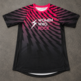 Load image into Gallery viewer, A short-sleeve athletic jersey laid flat on a gray textured surface. The shirt features a black base with a pink-to-purple-to-black gradient and diagonal lightning-bolt pattern across the body and sleeves.
